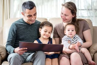 Happy Family Portrait. Mother And Father With Two Daughters